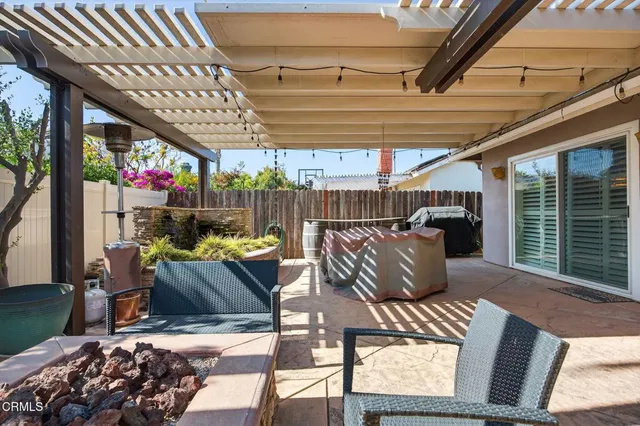a view of a patio with a table and chairs under an umbrella