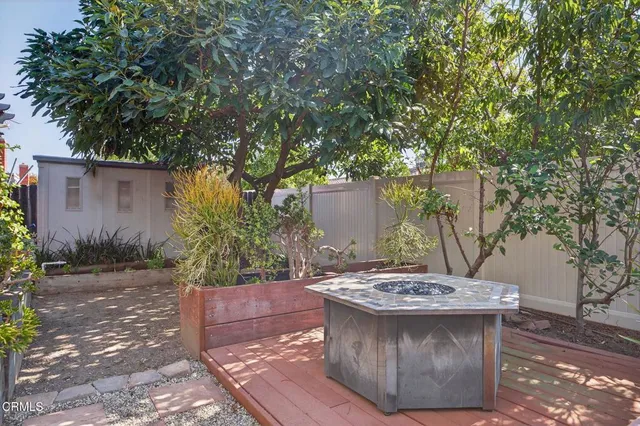 a view of a patio with table and chairs and potted plants