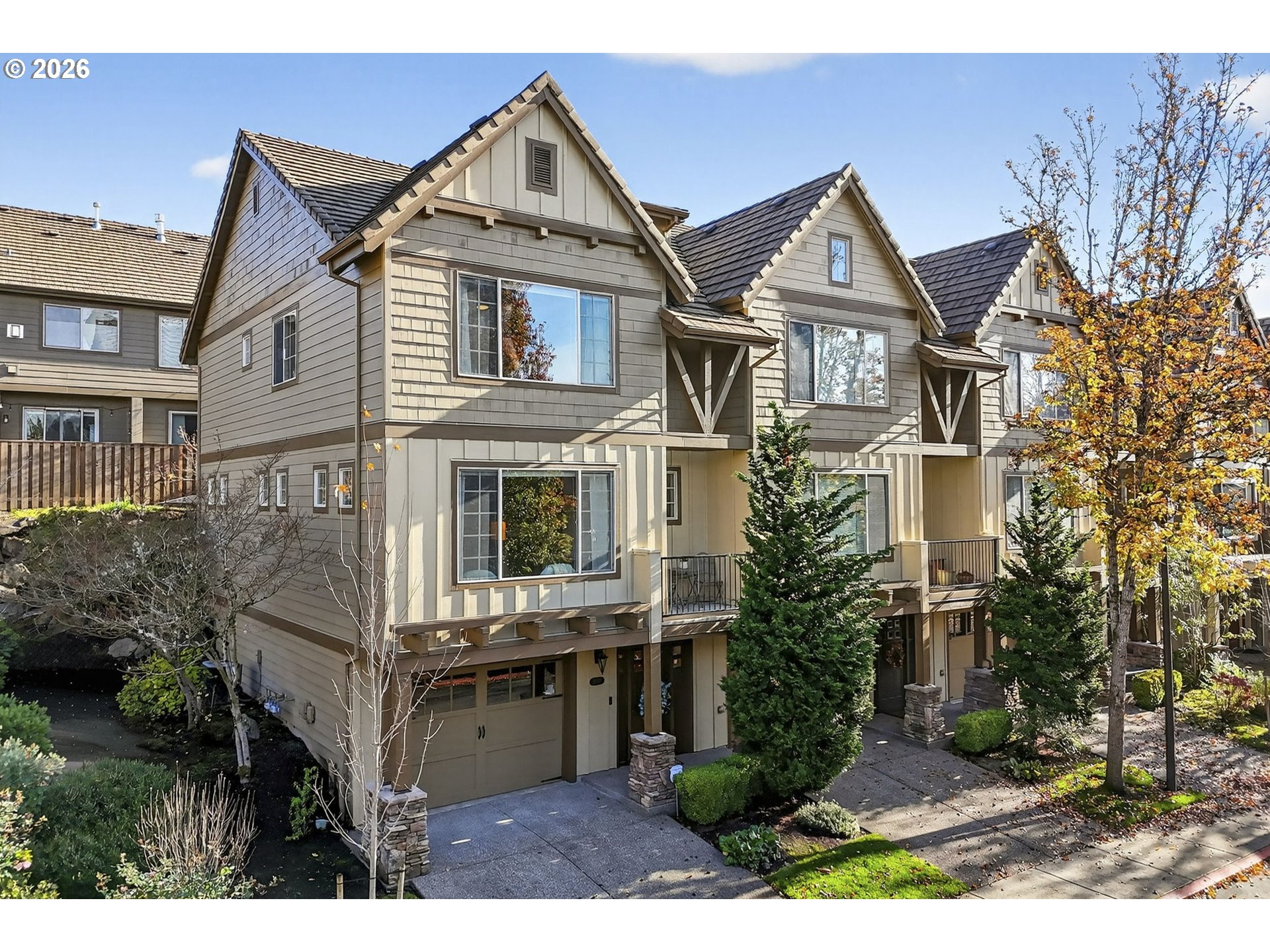 2064 Northwest Village Circle, Unit 44 Portland, OR 97229 - Photo 1 of 45 a view of a brick house with many windows and a yard