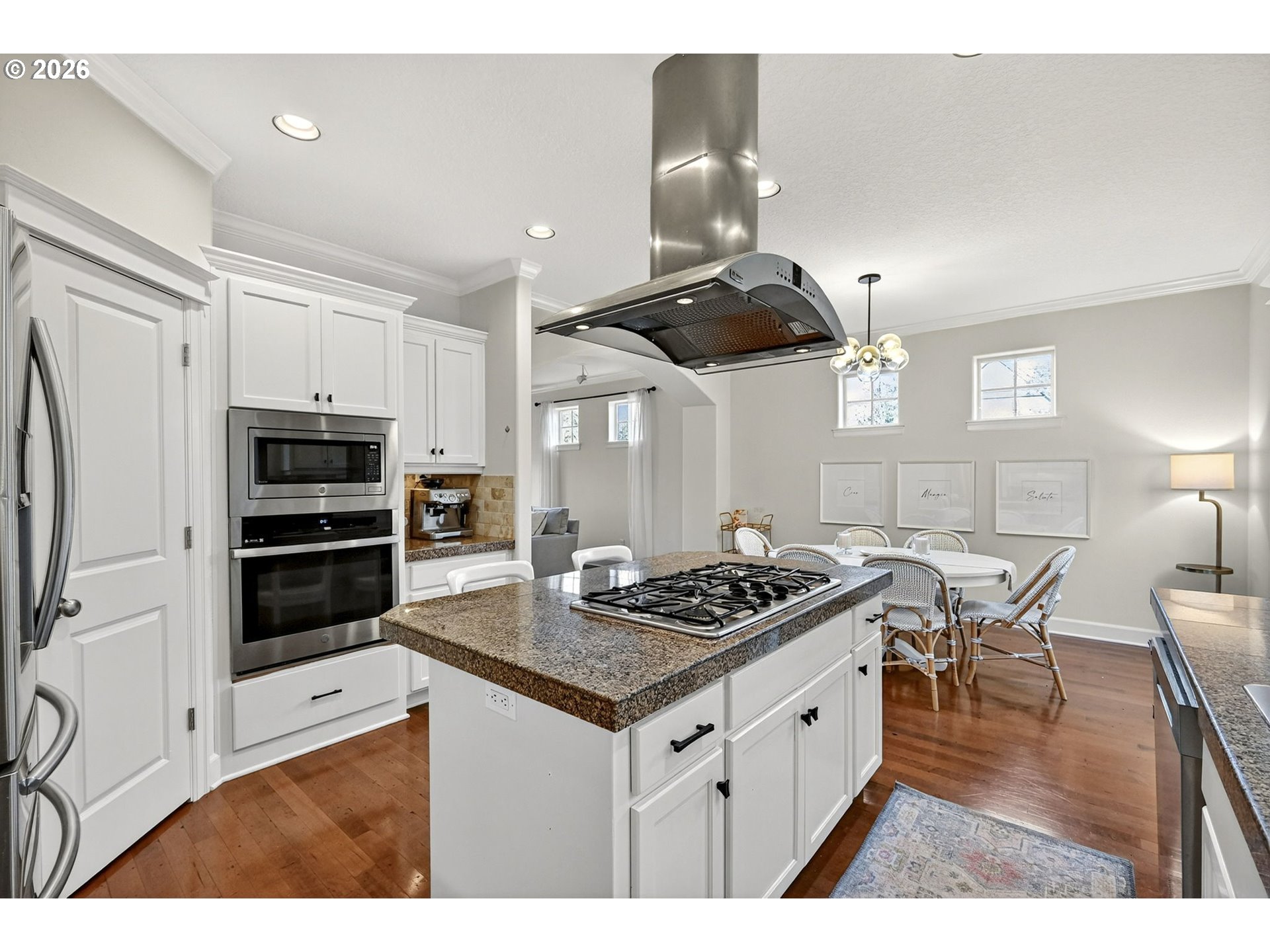 2064 Northwest Village Circle, Unit 44 Portland, OR 97229 - Photo 13 of 45 a kitchen with stainless steel appliances kitchen island granite countertop a stove and a refrigerator