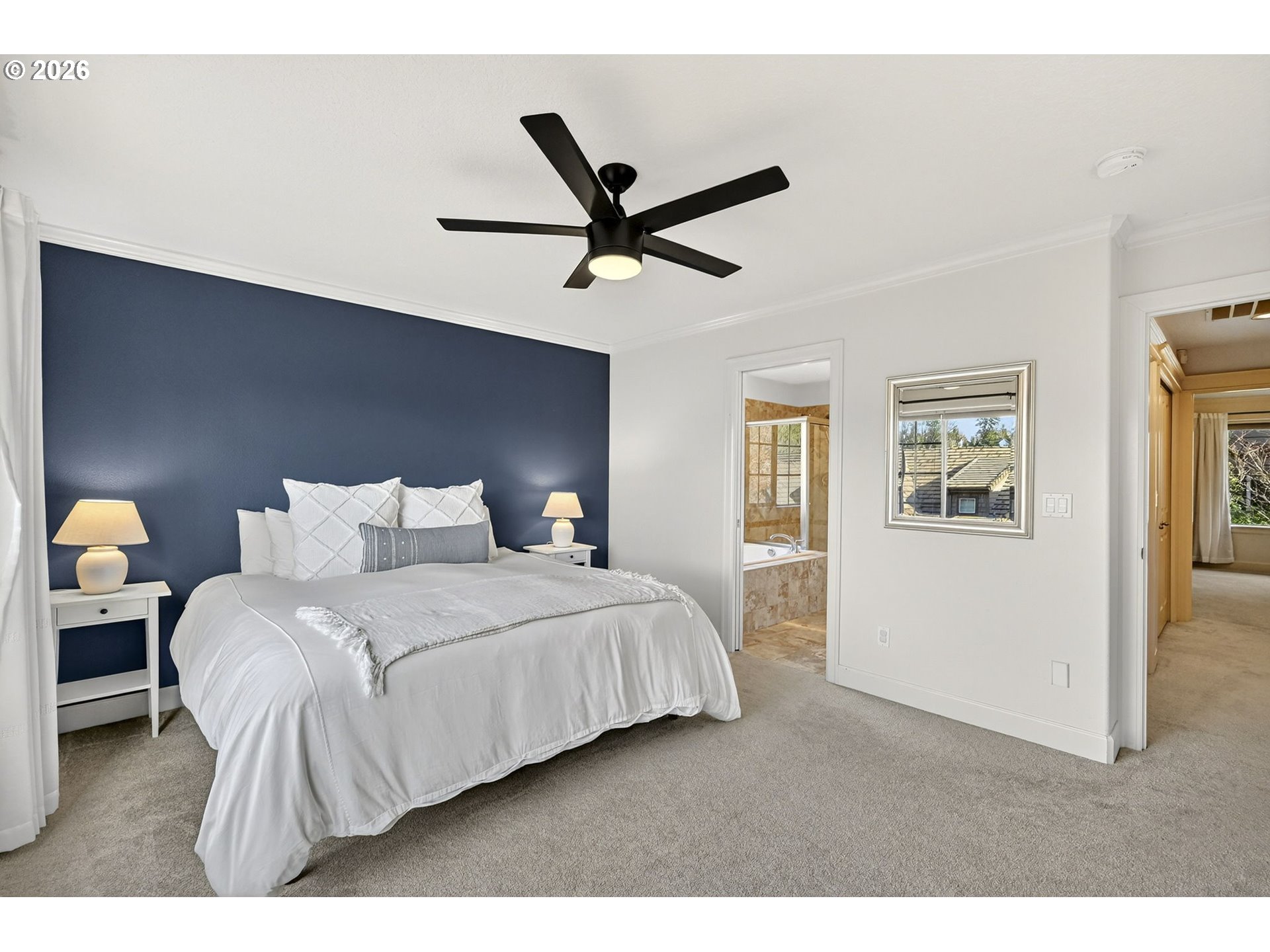 2064 Northwest Village Circle, Unit 44 Portland, OR 97229 - Photo 19 of 45 a bedroom with a bed and a ceiling fan
