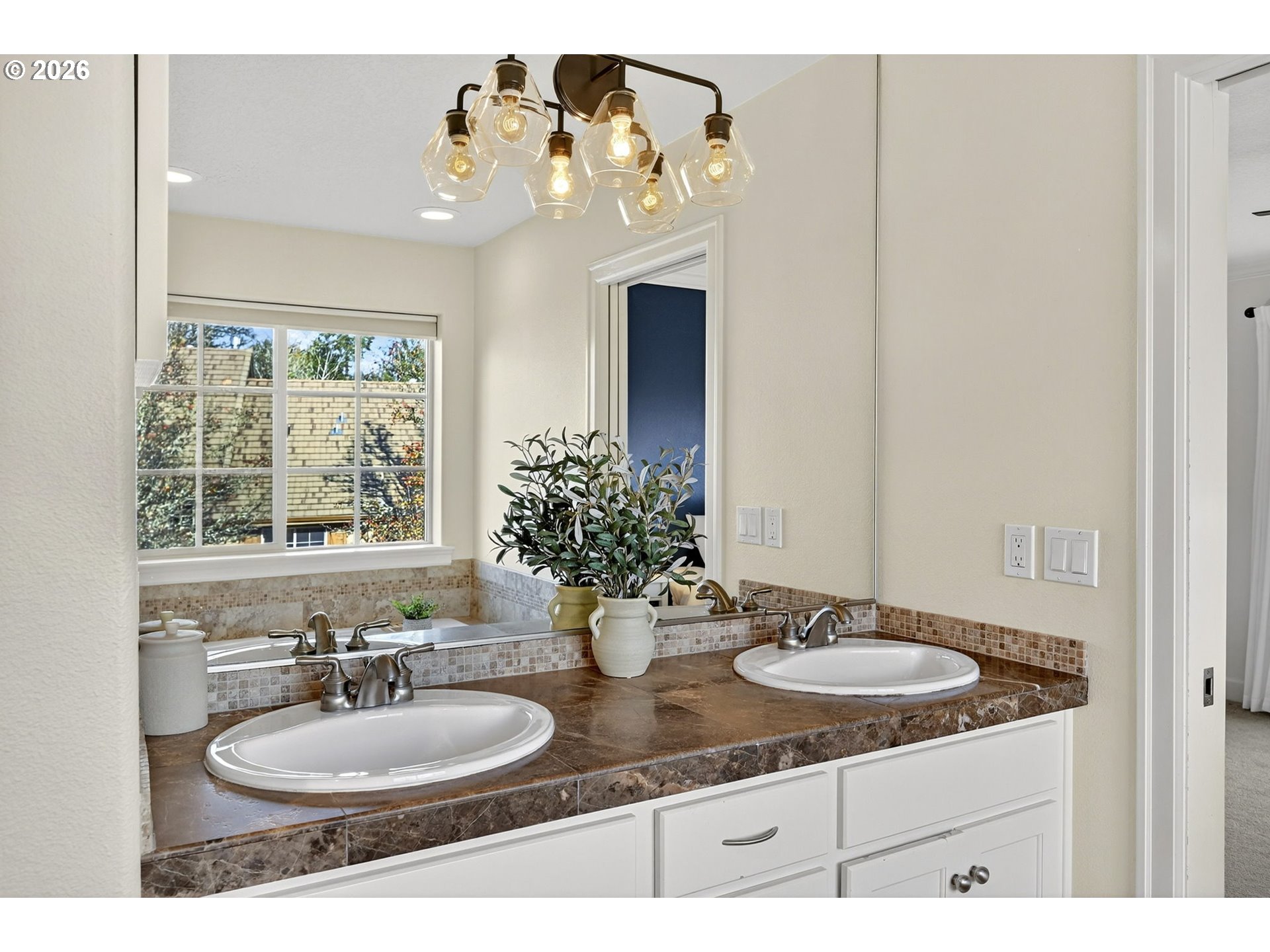 2064 Northwest Village Circle, Unit 44 Portland, OR 97229 - Photo 22 of 45 a bathroom with a granite countertop sink a large mirror and a window