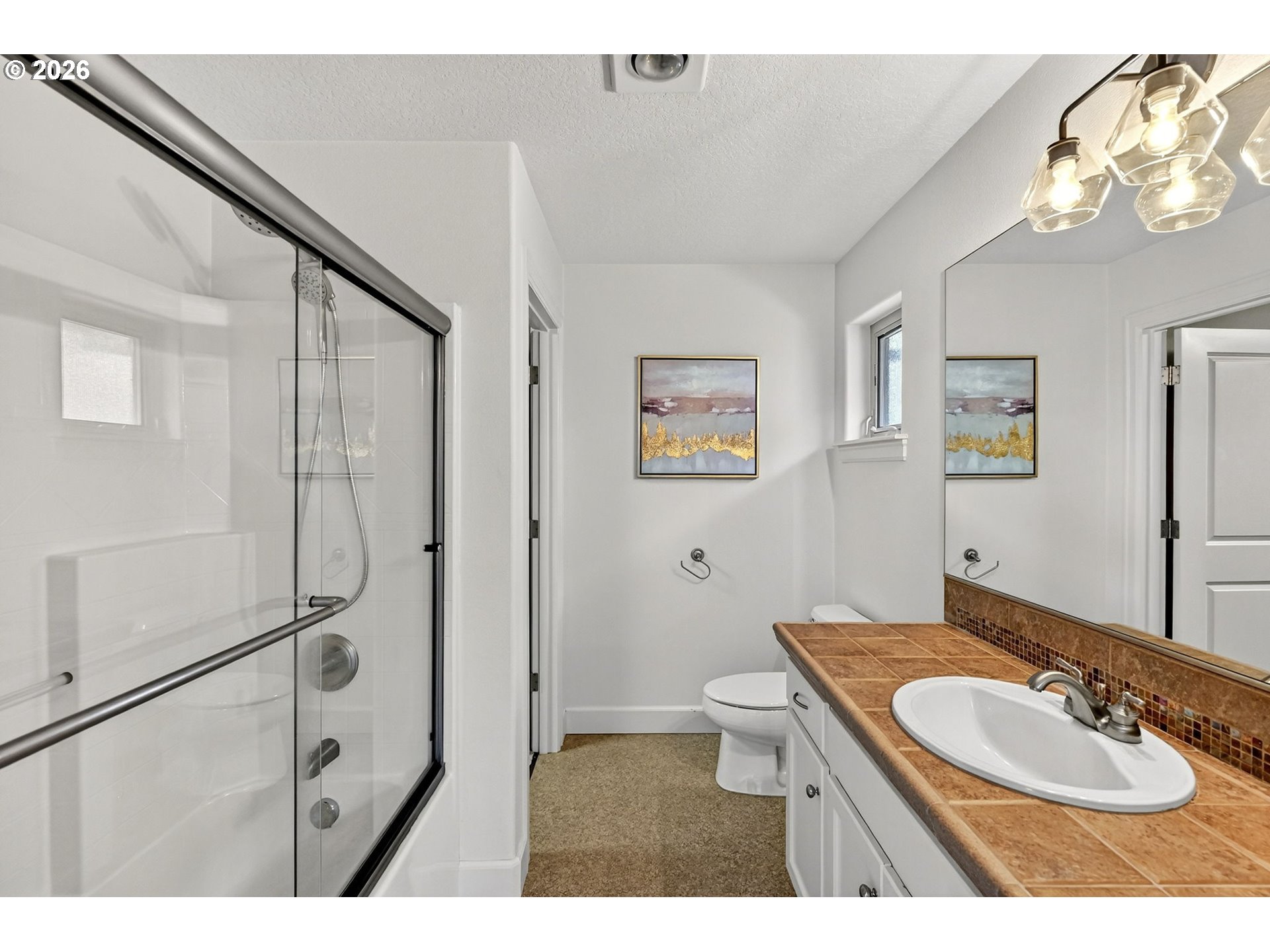 2064 Northwest Village Circle, Unit 44 Portland, OR 97229 - Photo 26 of 45 a bathroom with a sink toilet a mirror and shower