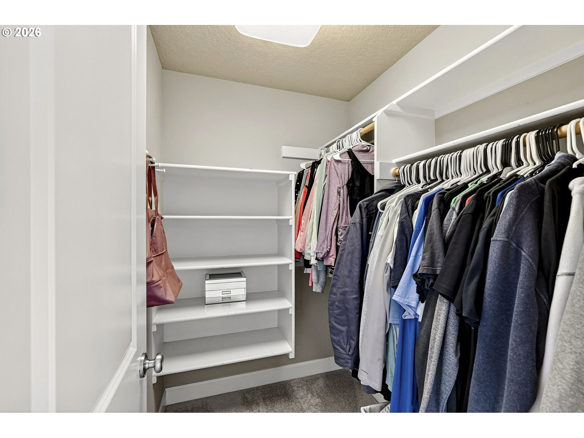 2064 Northwest Village Circle, Unit 44 Portland, OR 97229 - Photo 27 of 45 a view of walk in closet with clothes and shoes