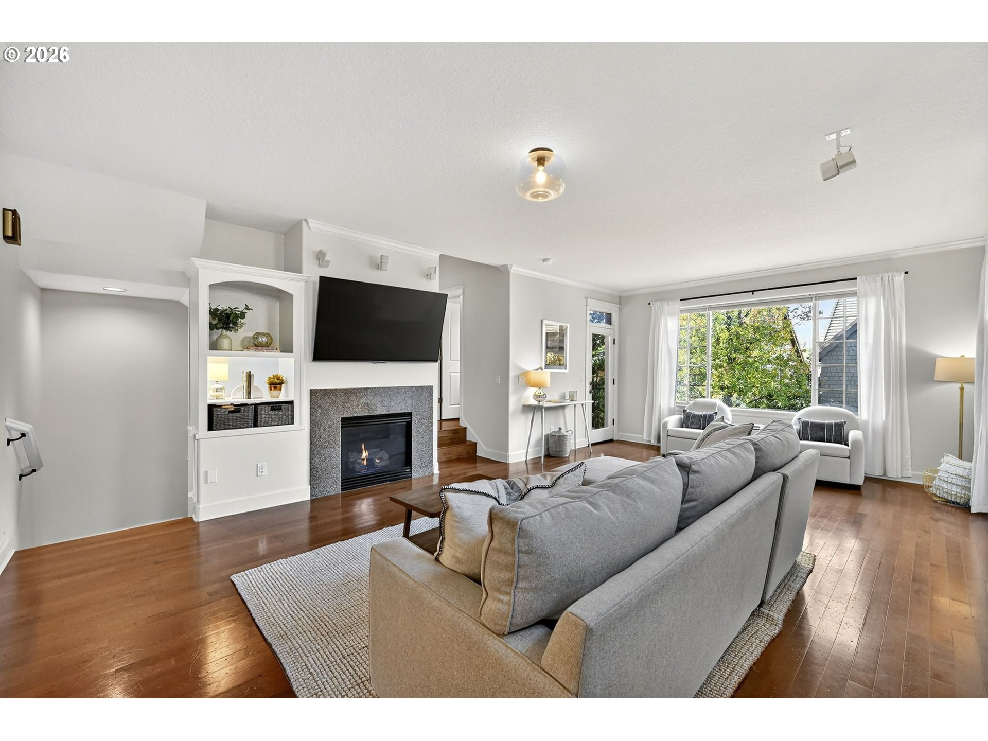 2064 Northwest Village Circle, Unit 44 Portland, OR 97229 - Photo 5 of 45 a living room with furniture a window and a fireplace