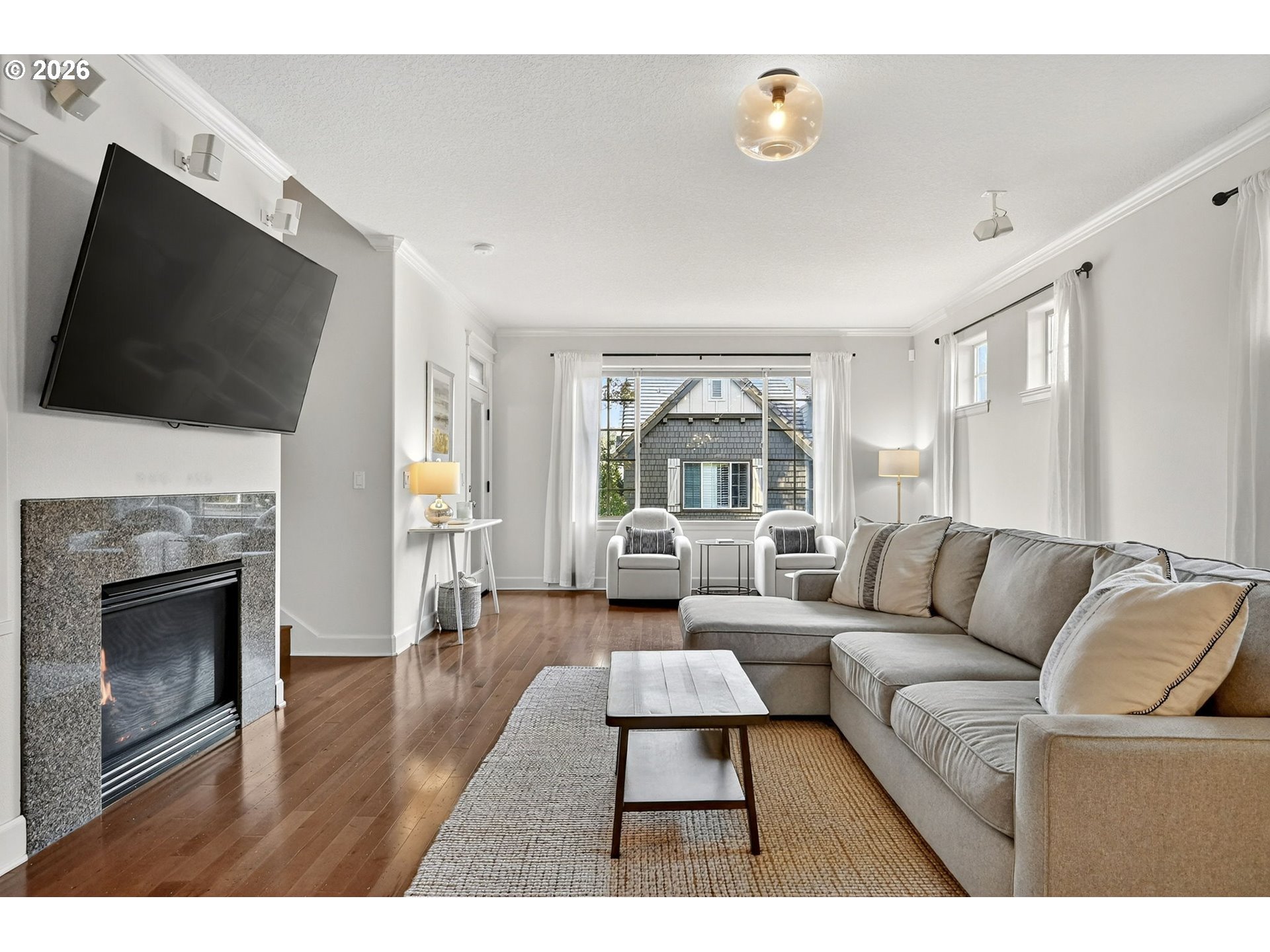 2064 Northwest Village Circle, Unit 44 Portland, OR 97229 - Photo 6 of 45 a living room with furniture a flat screen tv and a fireplace
