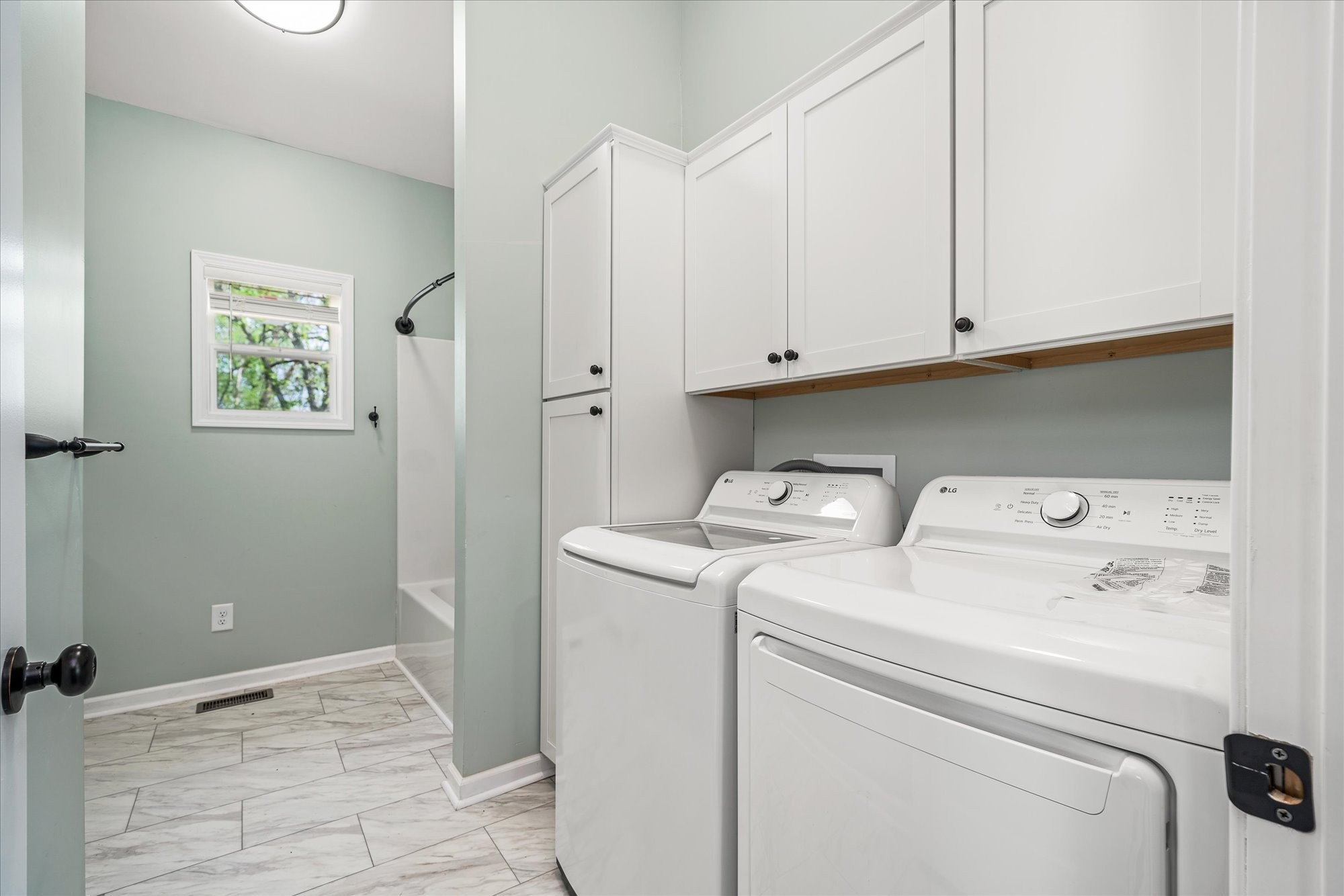3820 Jefferson Road Smithville, TN 37166 - Photo 7 of 15 a view of washer and dryer with bathroom in the background