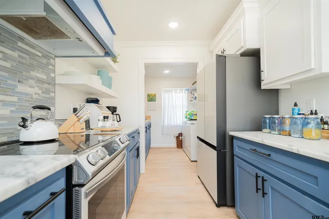 a kitchen with granite countertop a sink stove and cabinets