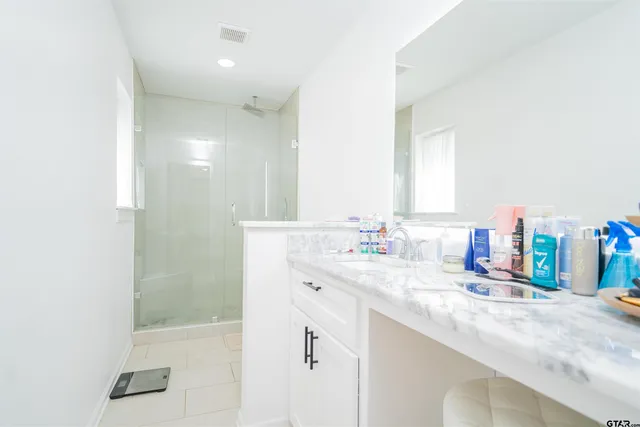 a bathroom with a sink vanity and a mirror