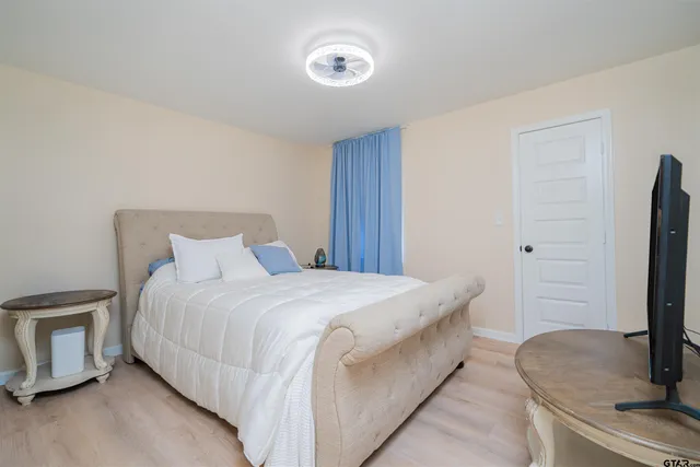 a bedroom with a bed and a flat screen tv