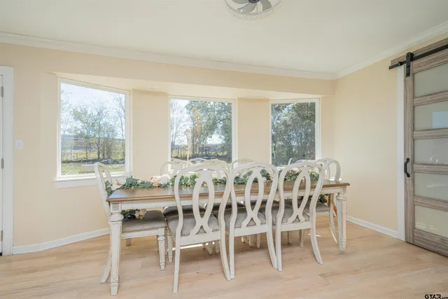 a view of a dining room with furniture window and outside view