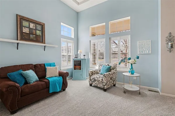 a living room with furniture and a floor to ceiling window
