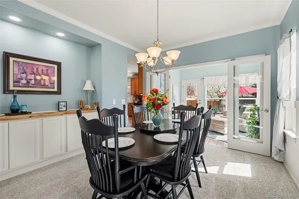 a view of a dining room with furniture and chandelier