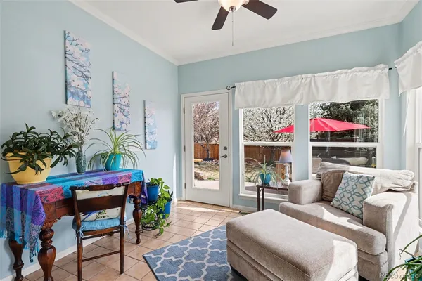 a living room with furniture and a potted plant