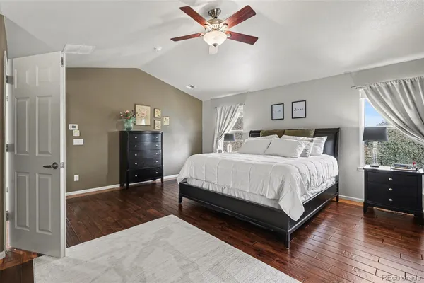 a spacious bedroom with a bed and a chandelier