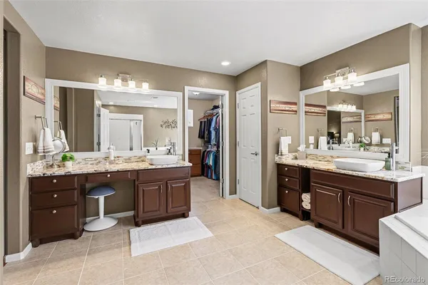 a large bathroom with a double vanity sink a large mirror and a shower