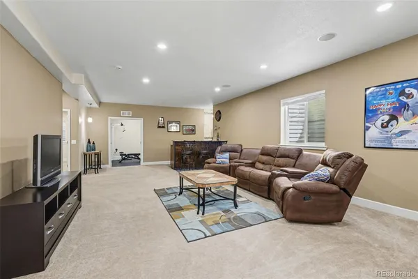 a living room with furniture a large window and a flat screen tv