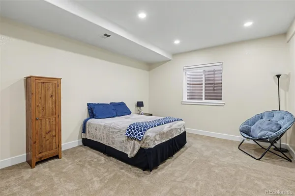 a living room with a bed furniture and a window