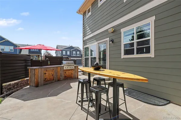 a table and chairs in front of a house