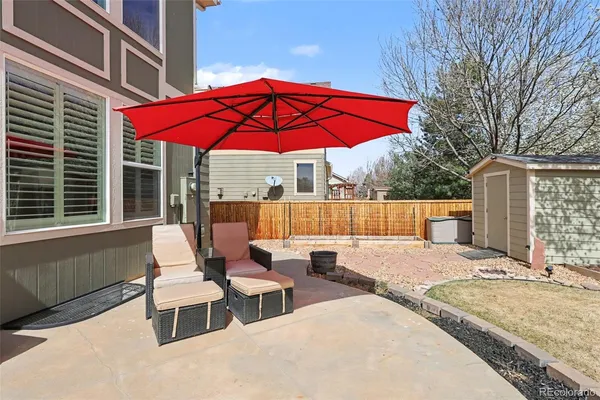 a view of backyard of house with seating space