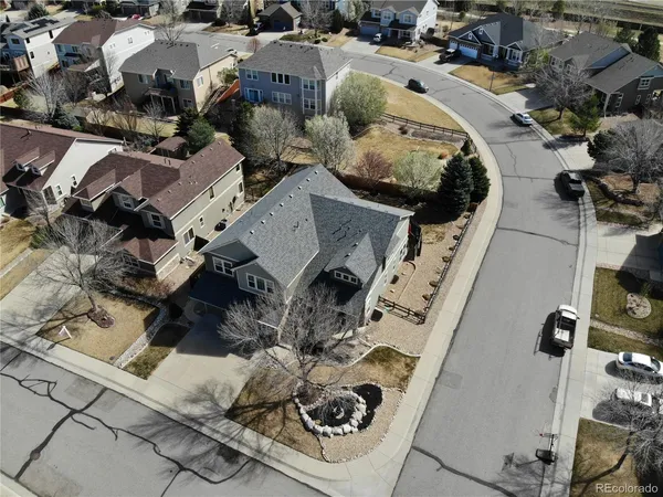 an aerial view of a house with garden space and parking