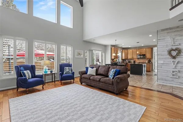 a living room with furniture wooden floor and a table