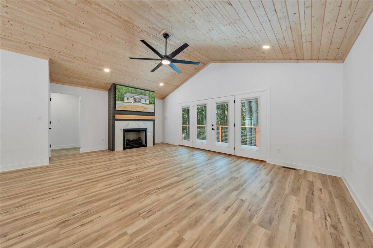 2365 Lakewood Forest Road Moneta, VA 24121 - Photo 13 of 90 a view of empty room with wooden floor and fireplace