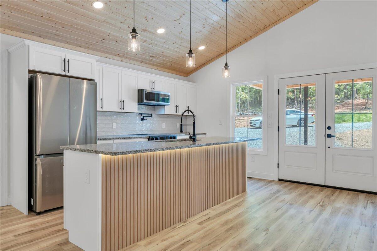 2365 Lakewood Forest Road Moneta, VA 24121 - Photo 16 of 90 a kitchen with stainless steel appliances granite countertop a refrigerator a sink dishwasher a stove and a refrigerator with wooden floor