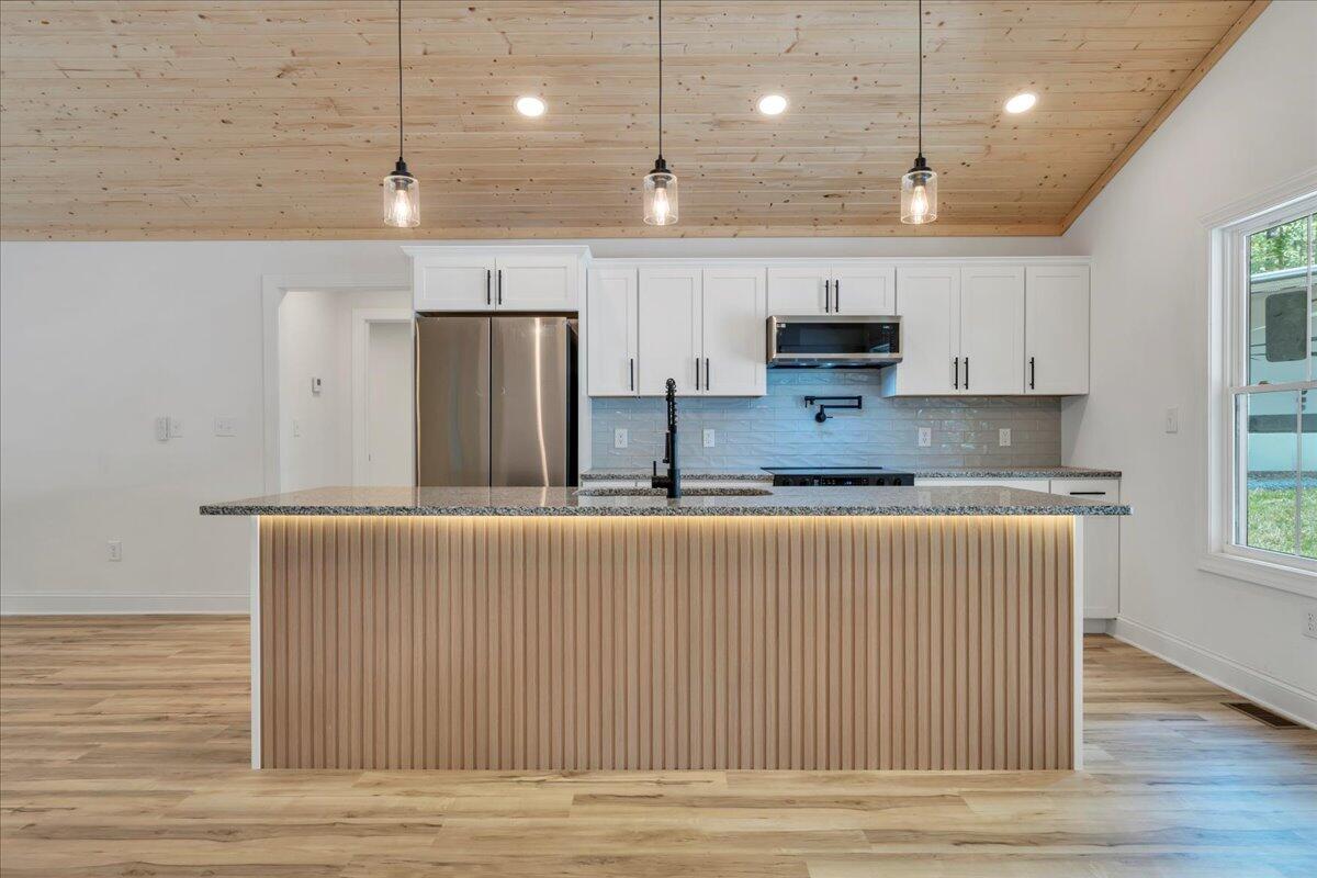 2365 Lakewood Forest Road Moneta, VA 24121 - Photo 17 of 90 a kitchen with stainless steel appliances granite countertop a stove a sink and a refrigerator