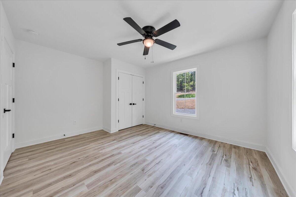 2365 Lakewood Forest Road Moneta, VA 24121 - Photo 28 of 90 an empty room with ceiling fan and window