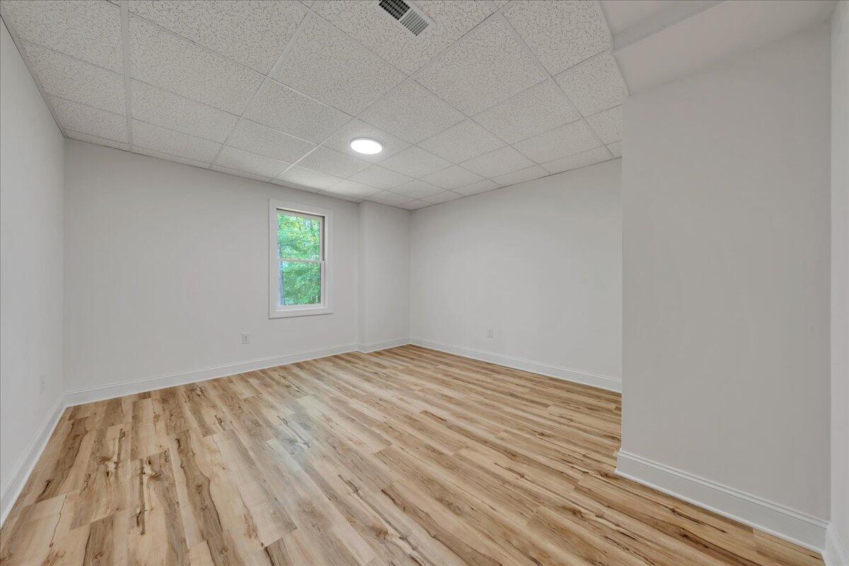 2365 Lakewood Forest Road Moneta, VA 24121 - Photo 34 of 90 a view of an empty room with wooden floor and a window