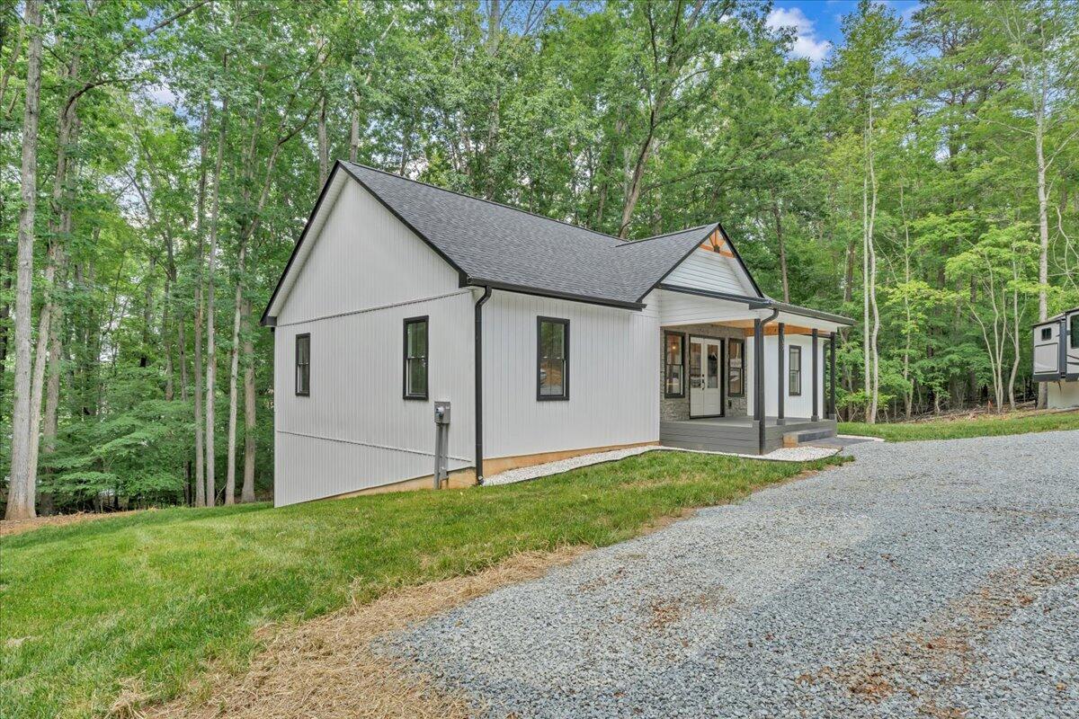 2365 Lakewood Forest Road Moneta, VA 24121 - Photo 49 of 90 a view of a yard in front of a house with large trees