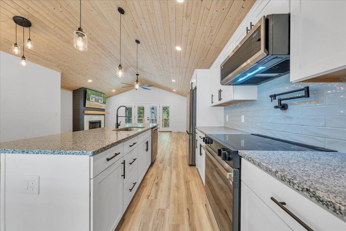 2365 Lakewood Forest Road Moneta, VA 24121 - Photo 10 of 90 a kitchen with granite countertop a sink and a stove