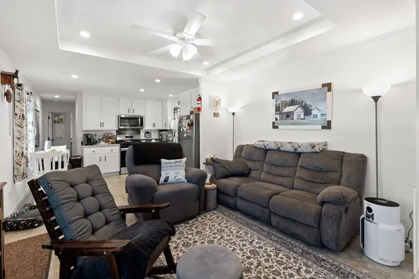 a living room with furniture and kitchen view
