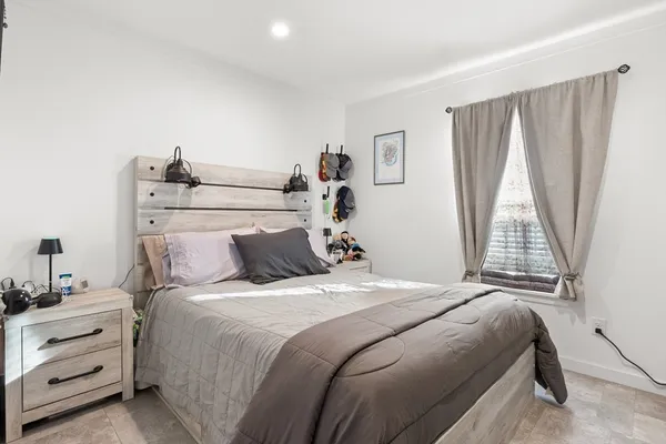 a bedroom with a bed and a window
