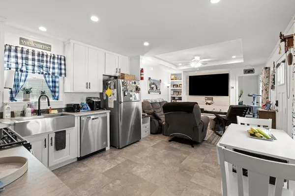 a view of a kitchen with refrigerator stove and a sink