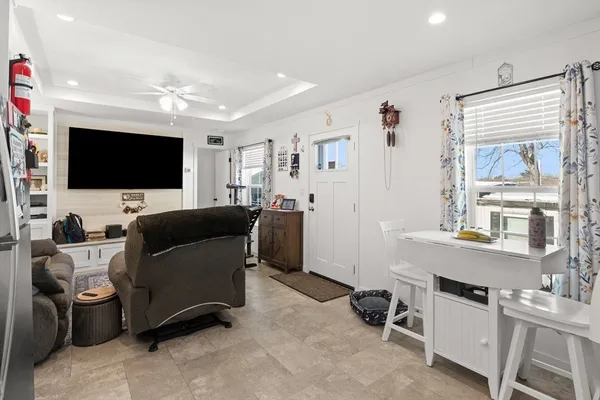 a view of a livingroom with workspace and a window