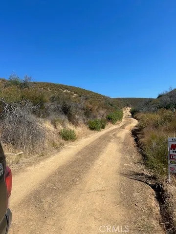 a view of a road with mountains in the background