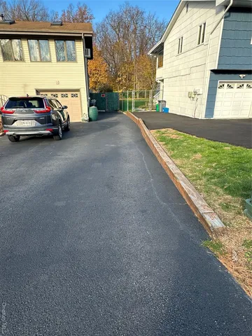 a view of a car park in front of a house