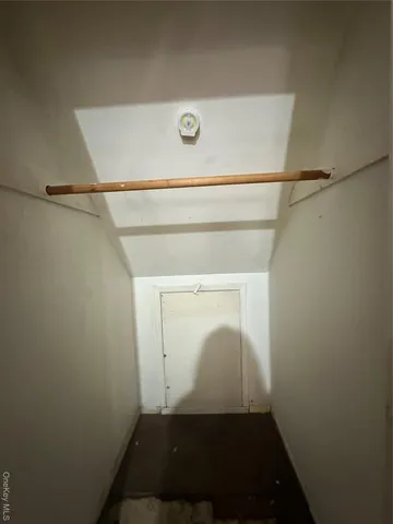 a view of storage and utility room with wooden floor