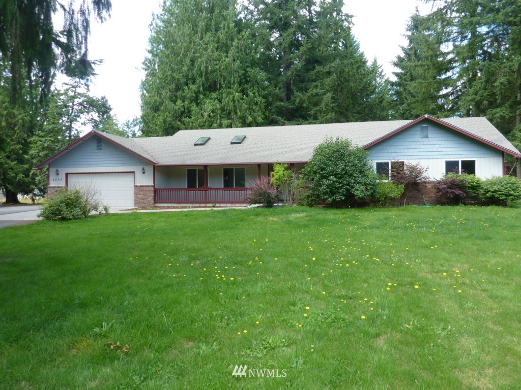 5508 133rd Avenue Southwest Rochester, WA 98579 - Photo 1 of 1 a front view of a house with a yard and trees