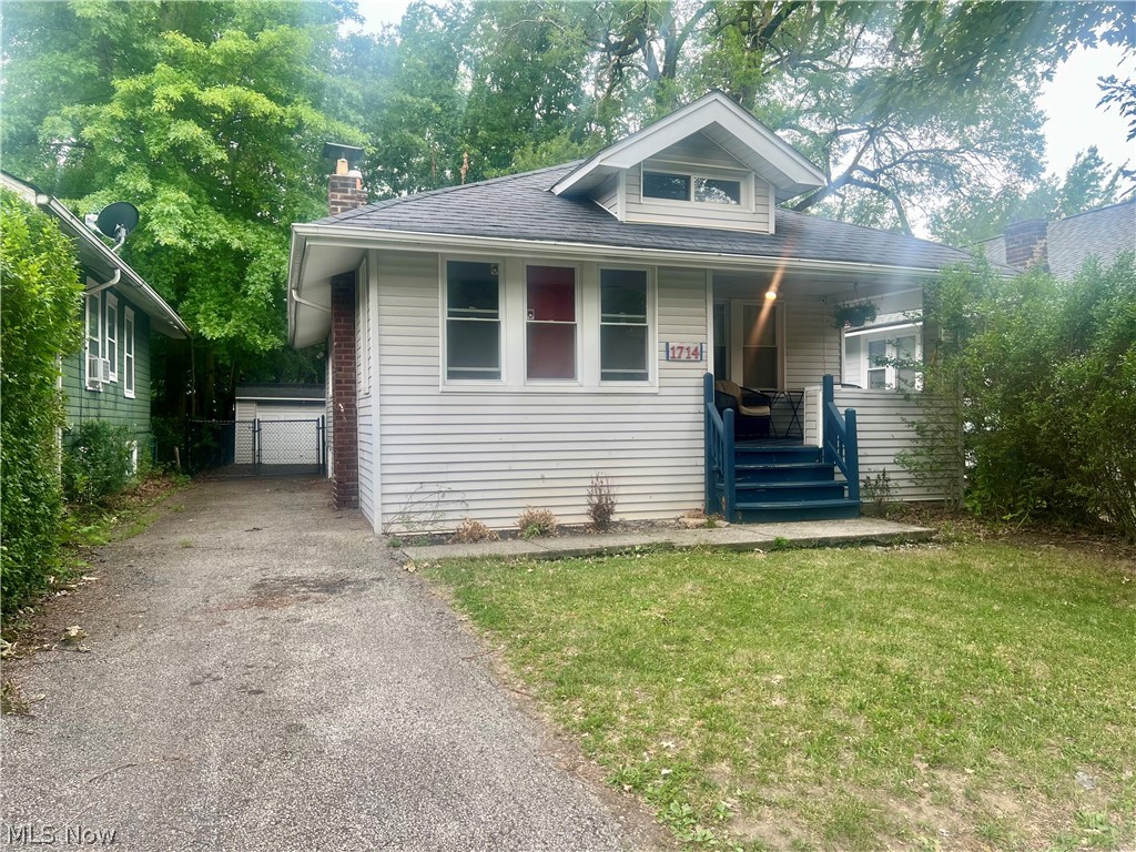 1714 Hillview Road Cleveland, OH 44112 - Photo 2 of 17 Bungalow-style house featuring covered porch and a front lawn