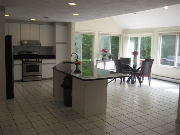 17 Aspen Road Sharon, MA 02067 - Photo 3 of 21 a dining hall with granite countertop a stove a sink a dining table and chairs