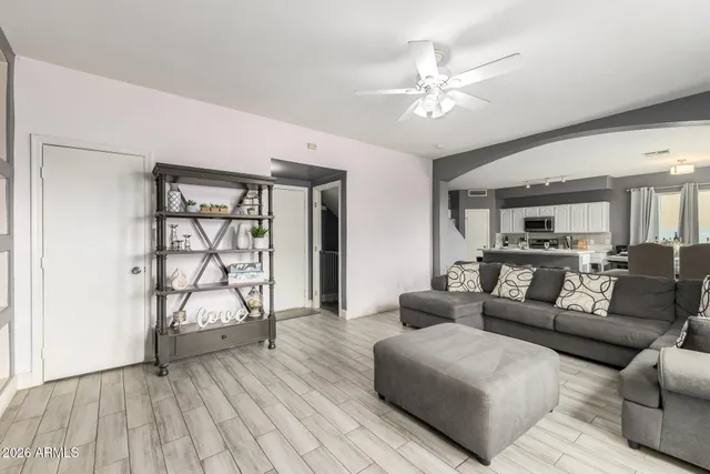 a living room with furniture and wooden floor