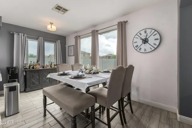 a view of a dining room with furniture window and wooden floor
