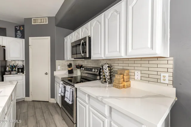 a kitchen with stainless steel appliances a sink a stove and a refrigerator