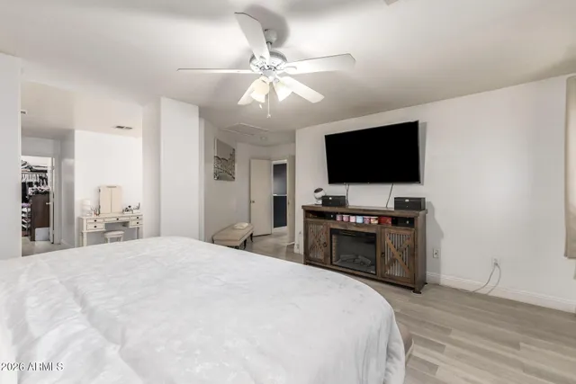 a bedroom with a bed and a flat screen tv