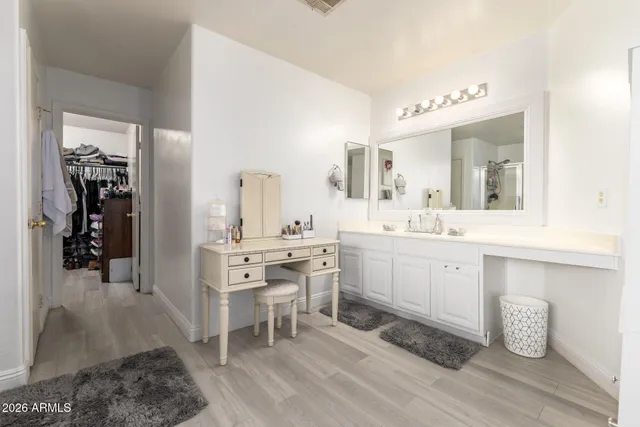 a spacious bathroom with a double vanity sink and a mirror