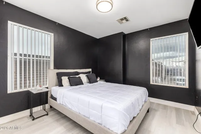 a bedroom with a large bed and a view of living room