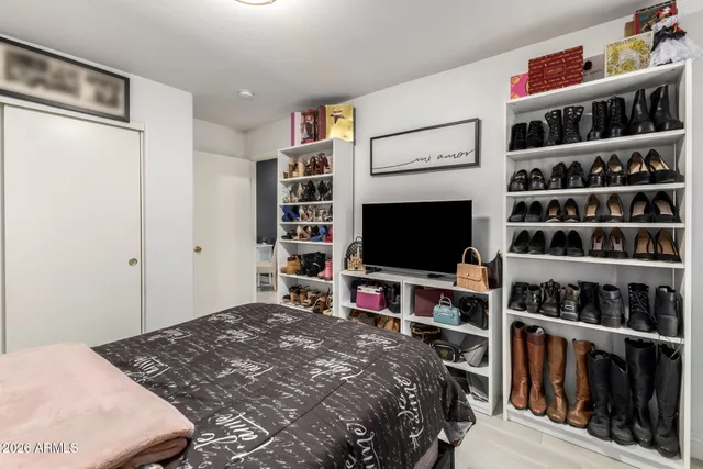 a bedroom with a bed and a flat screen tv